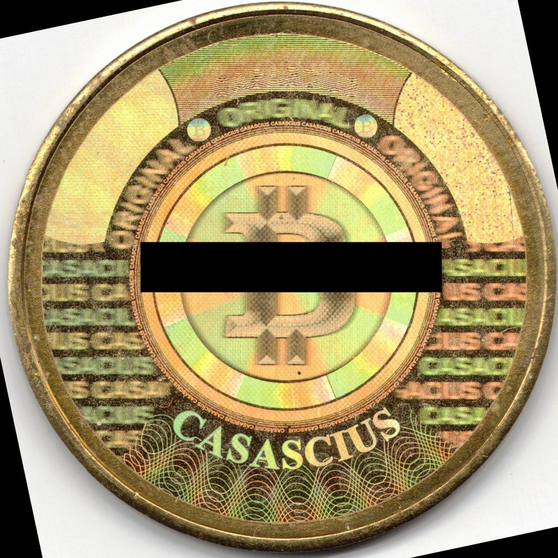 เหรียญ Casascius 1 BTC ซีรีส์แรกปี 2011 ด้านโฮโลแกรมที่สะกดผิดเป็น CASACIUS